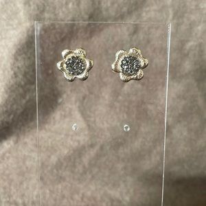 Flower shape earrings with grey tone crystal centers.